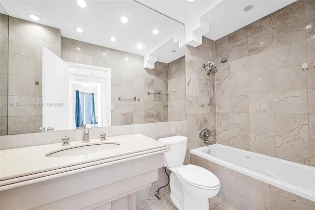 a view of a hallway with furniture and a large window