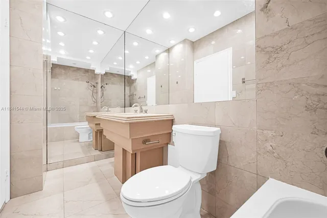 a view of living room kitchen and entryway