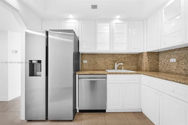 a kitchen with a sink stainless steel appliances and cabinets