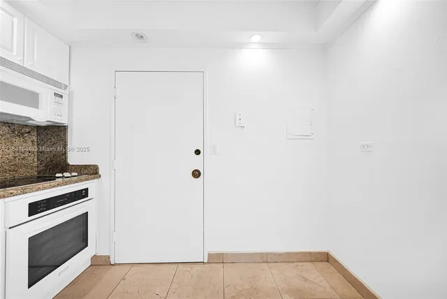 a view of a kitchen with an empty room