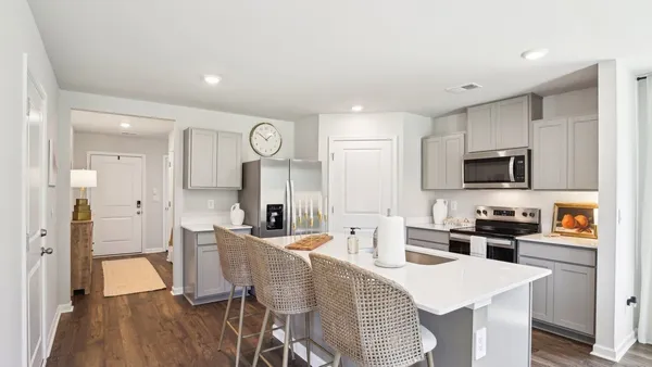 a large kitchen with a table and chairs