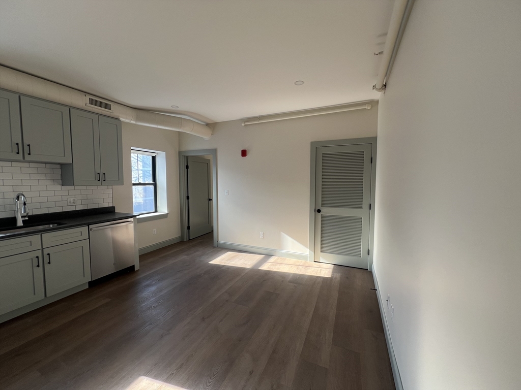 160 Seabury Street, Unit 11 Fall River, MA 02720 - Photo 4 of 10 a view of a kitchen cabinets a sink and wooden floor