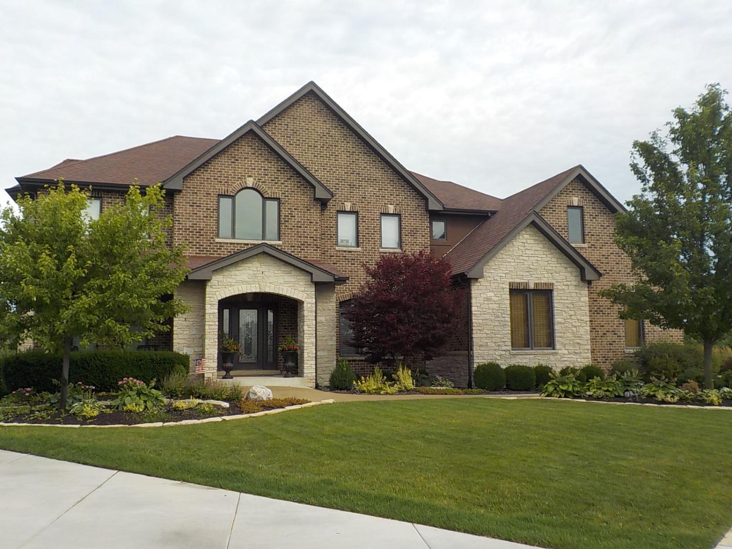 a front view of a house with a garden