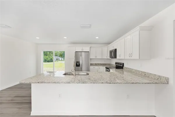 a kitchen with stainless steel appliances granite countertop a sink and a granite counter tops