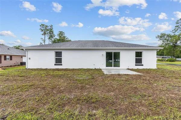 a view of a house with a backyard
