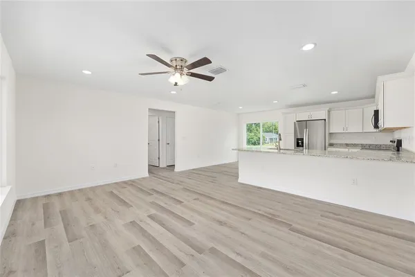 a view of a kitchen with an empty space and a ceiling fan