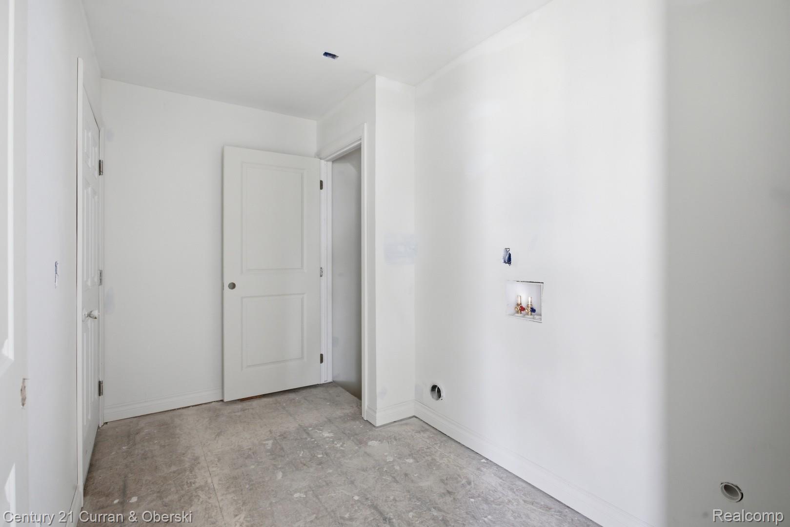 823 Nelson's Ridge Drive, Unit 13 Howell, MI 48843 - Photo 22 of 30 Utility room featuring white walls, a concrete floor, and pre-installed plumbing connections for appliances