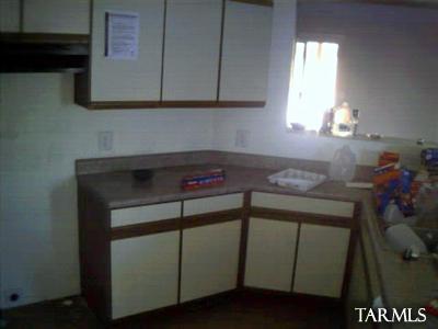 5740 South Manta Ray Road Tucson, AZ 85706 - Photo 3 of 5 a kitchen with cabinets and a wooden floor