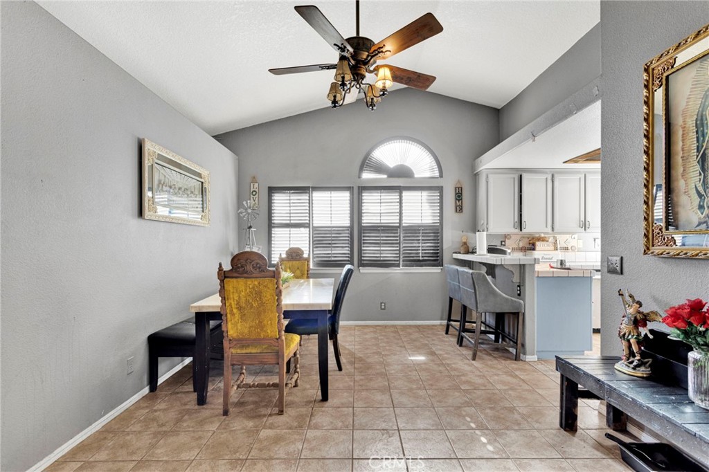 6414 Nielson Road Phelan, CA 92371 - Photo 16 of 74 a view of a dining room with furniture and a large window