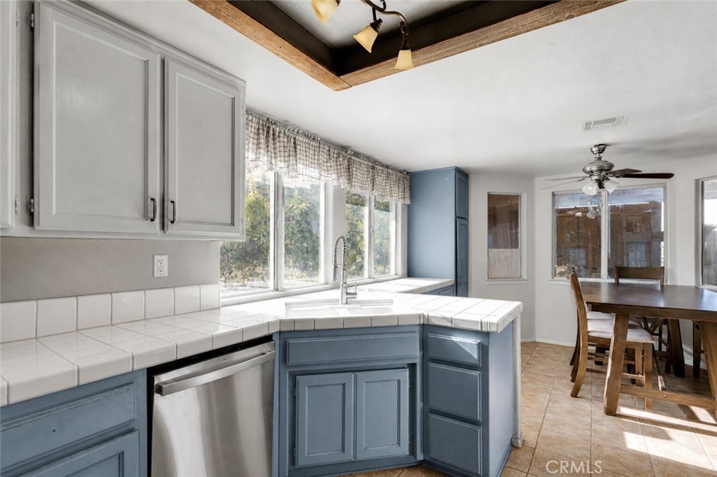 6414 Nielson Road Phelan, CA 92371 - Photo 22 of 74 a kitchen with granite countertop a sink and white cabinets