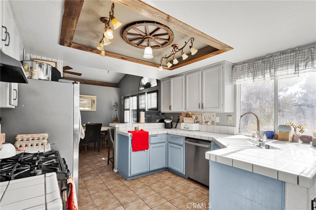 6414 Nielson Road Phelan, CA 92371 - Photo 23 of 74 a kitchen with a sink cabinets and appliances
