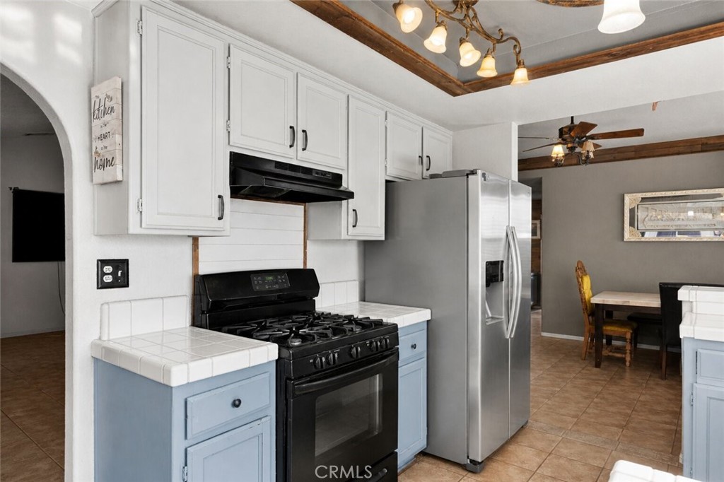 6414 Nielson Road Phelan, CA 92371 - Photo 26 of 74 a kitchen with stainless steel appliances granite countertop a stove a refrigerator and a sink