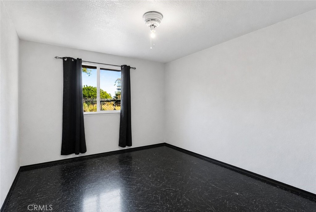 6414 Nielson Road Phelan, CA 92371 - Photo 34 of 74 an empty room with wooden floor and windows