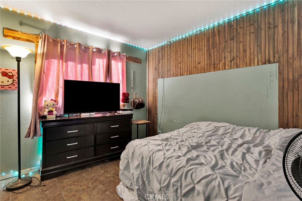 6414 Nielson Road Phelan, CA 92371 - Photo 51 of 74 a bedroom with a bed and a flat screen tv