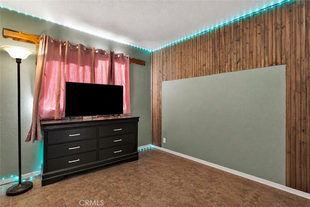 6414 Nielson Road Phelan, CA 92371 - Photo 52 of 74 a room with furniture and a flat screen tv