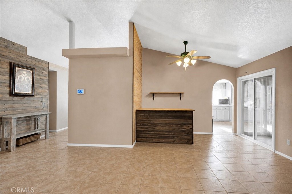 6414 Nielson Road Phelan, CA 92371 - Photo 9 of 74 a view of a hallway with a fireplace and a chandelier