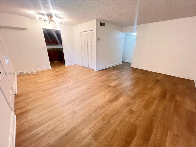 a view of a livingroom with wooden floor and ceiling fan