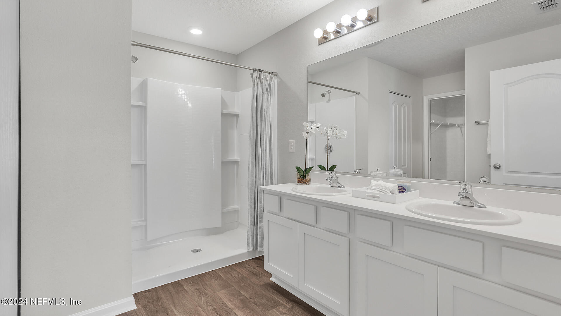 75 Hulett Wds Road Palm Coast, FL 32137 - Photo 19 of 38 a bathroom with a double vanity sink and a mirror