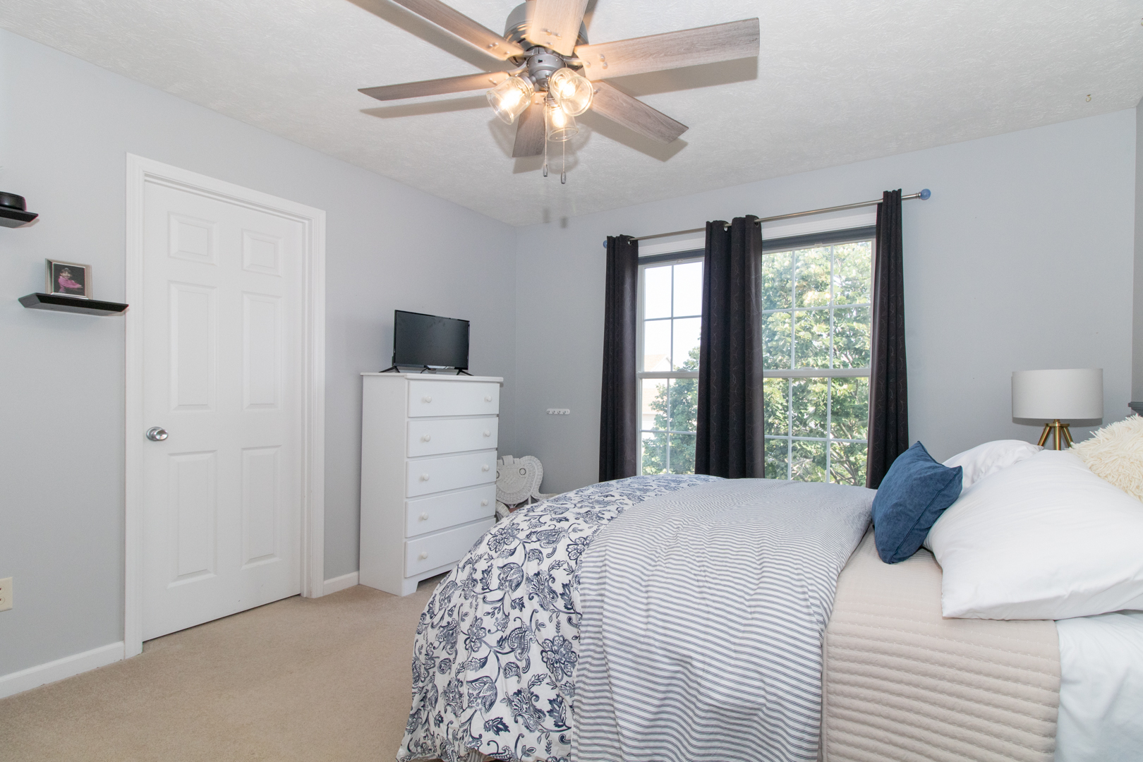 2973 Three Eagles Street Normal, IL 61761 - Photo 26 of 56 a bedroom with a bed and a flat tv screen on dresser