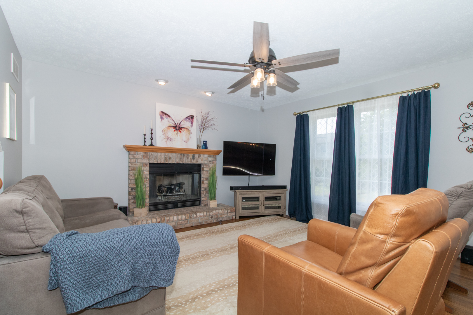 2973 Three Eagles Street Normal, IL 61761 - Photo 9 of 56 a living room with furniture a fireplace and a flat screen tv