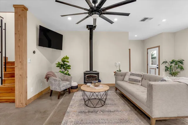a living room with furniture and a potted plant