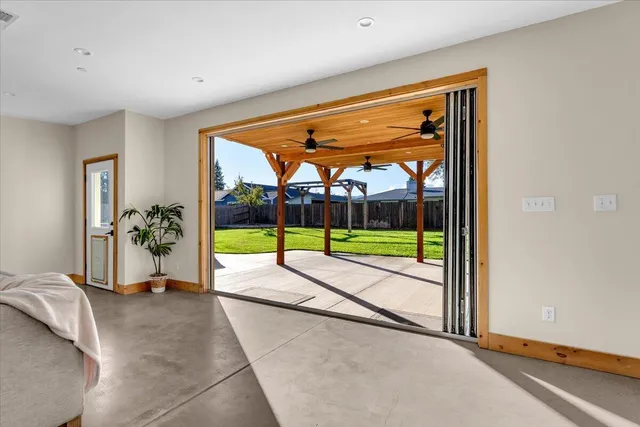 a view of a porch with furniture and a backyard