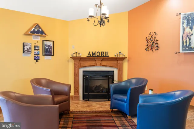 a bedroom with two beds and a painting on the wall