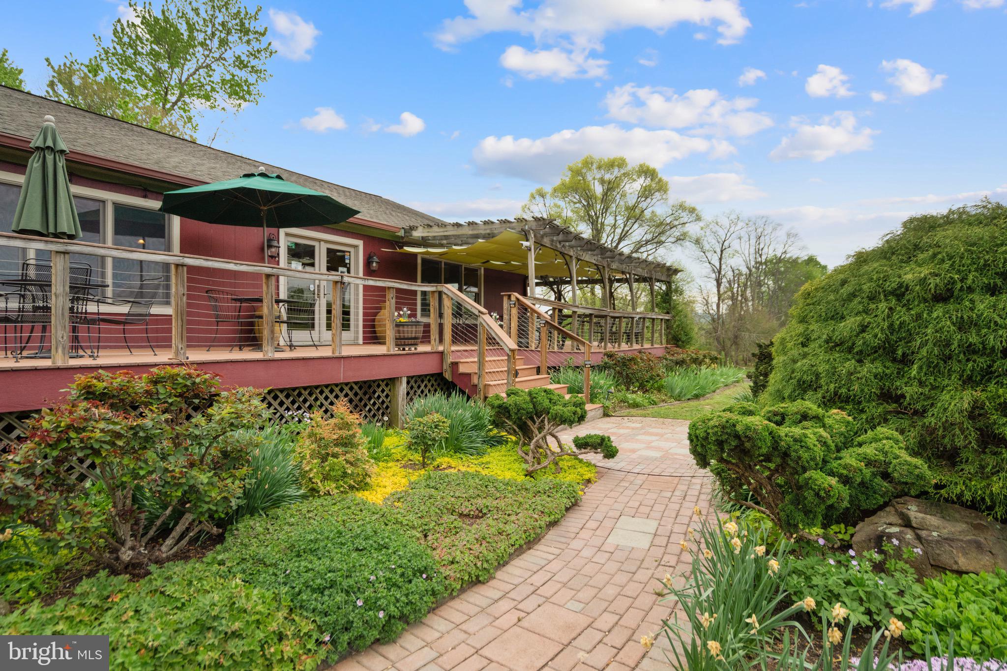 92 School House Road Washington, VA 22747 - Photo 28 of 68 a front view of a house with a yard and potted plants