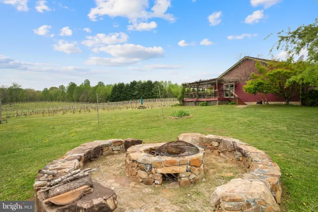 a living room with fireplace furniture and a chandelier