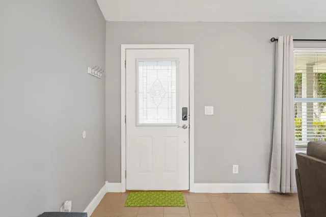 a view of bathroom with window and door