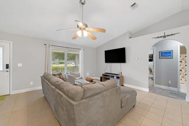 a living room with furniture and a flat screen tv