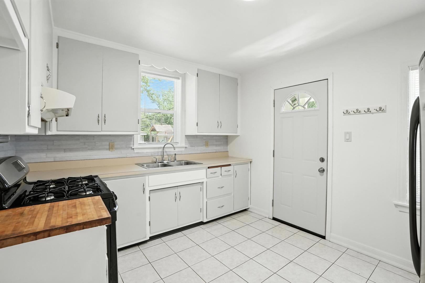 21149 Main Street Matteson, IL 60443 - Photo 12 of 20 a kitchen with a sink cabinets and window