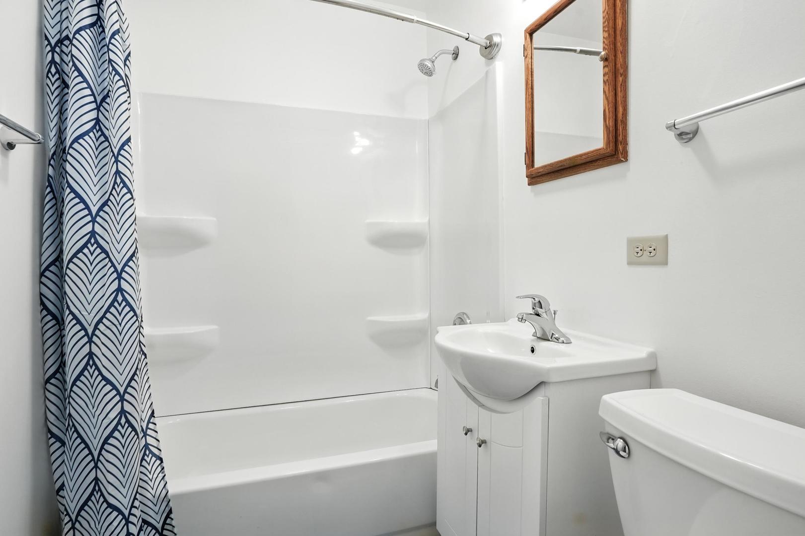 21149 Main Street Matteson, IL 60443 - Photo 15 of 20 a bathroom with a sink a toilet and shower