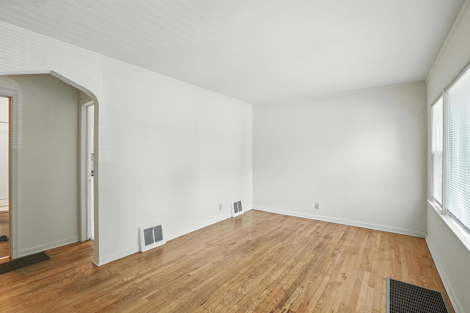 21149 Main Street Matteson, IL 60443 - Photo 4 of 20 an empty room with wooden floor and windows