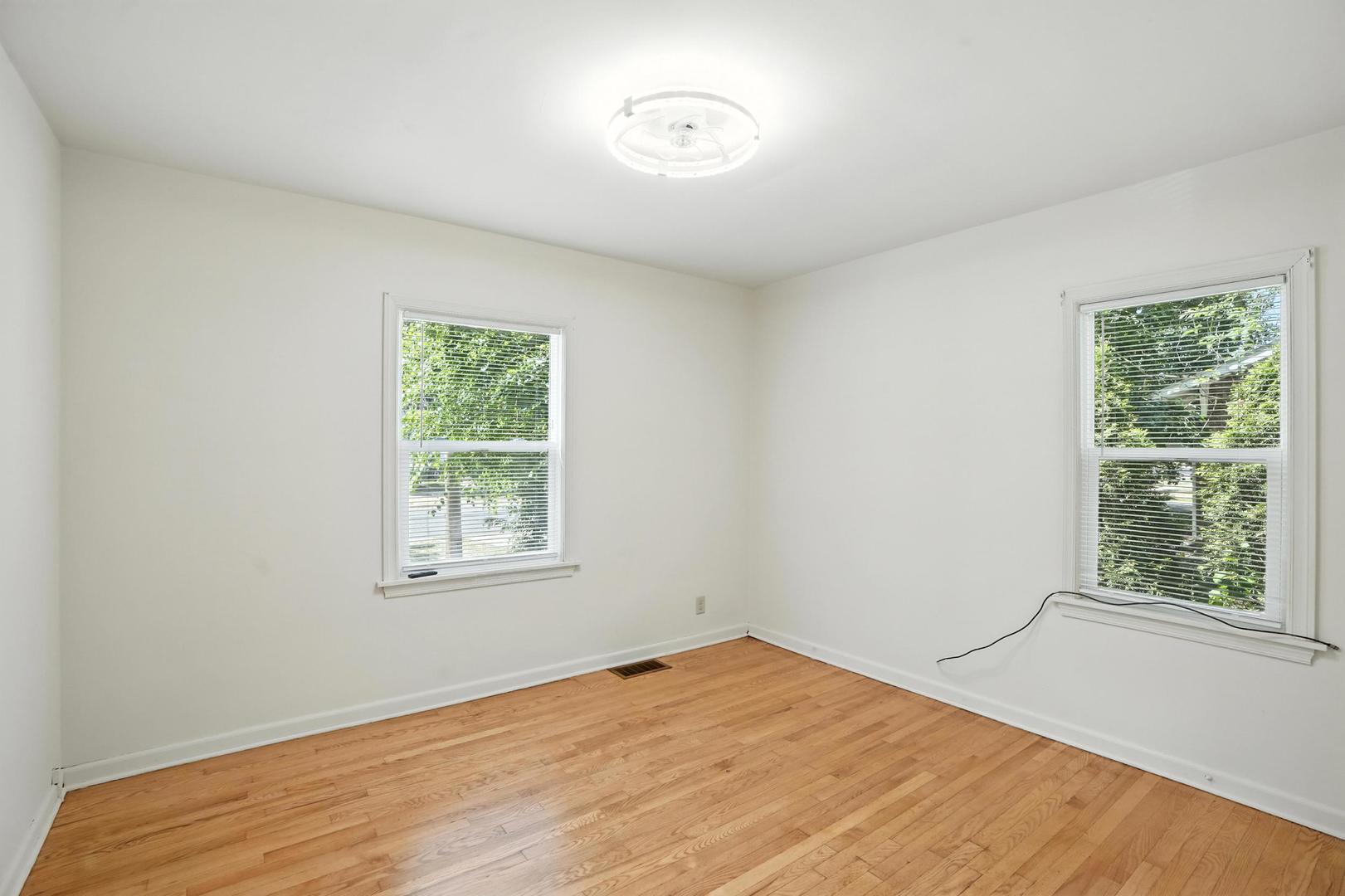 21149 Main Street Matteson, IL 60443 - Photo 8 of 20 a view of a room with wooden floor and windows
