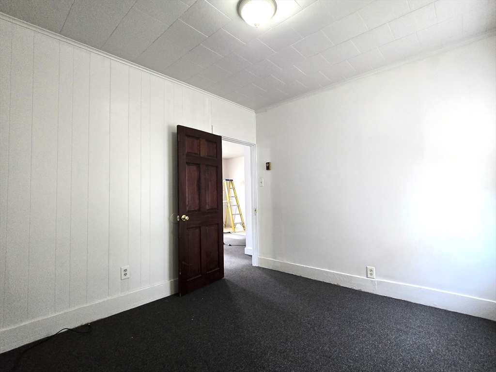 25 Myrtle Street, Unit 1F Taunton, MA 02780 - Photo 4 of 7 an empty room with closet