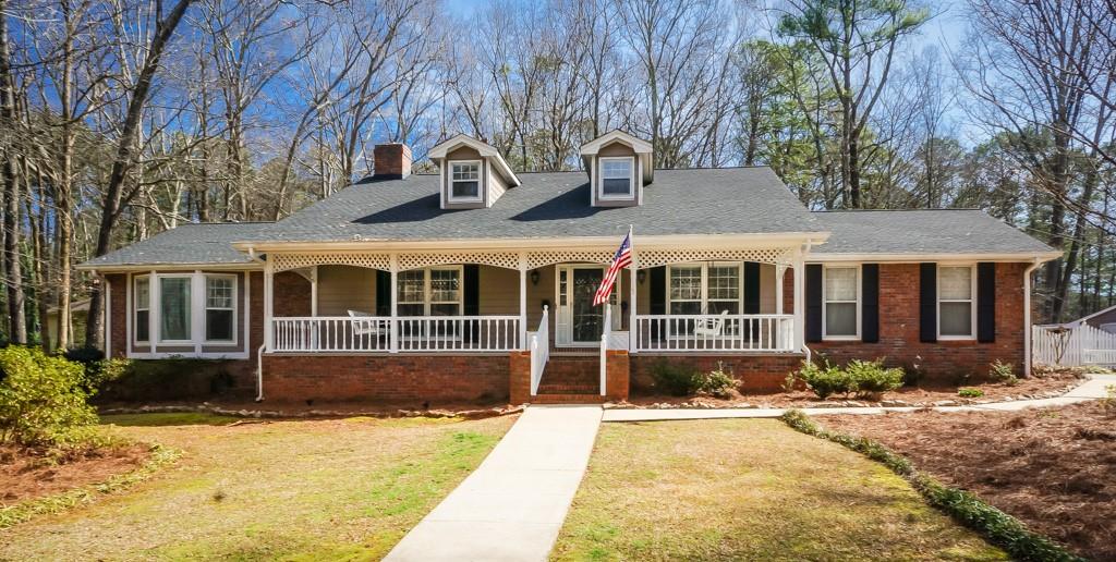 5331 Oxbow Road Stone Mountain, GA 30087 - Photo 1 of 1 a front view of a house with a yard and potted plants