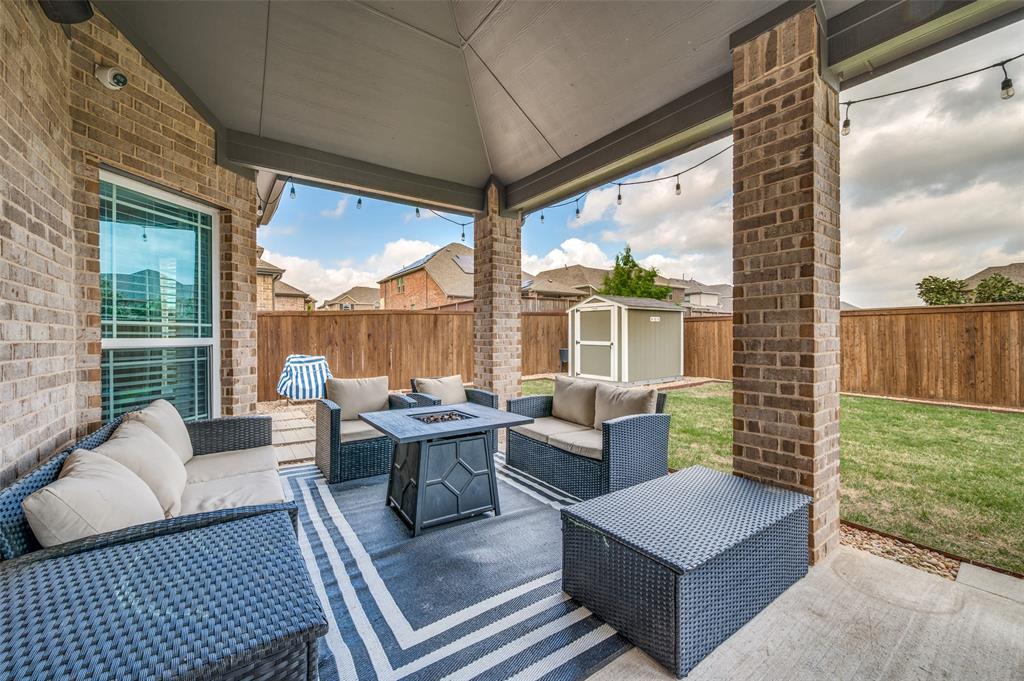 808 Violet Way Celina, TX 75009 - Photo 23 of 30 An outdoor living space o extended covered patio. A storage unit that will convey.