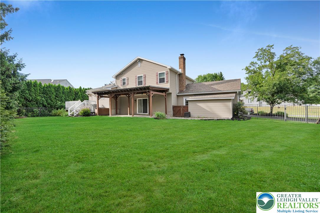 3396 Darien Road Bethlehem, PA 18020 - Photo 35 of 44 An inviting rear yard with a covered patio and verdant lawn offers plentiful outdoor living space.