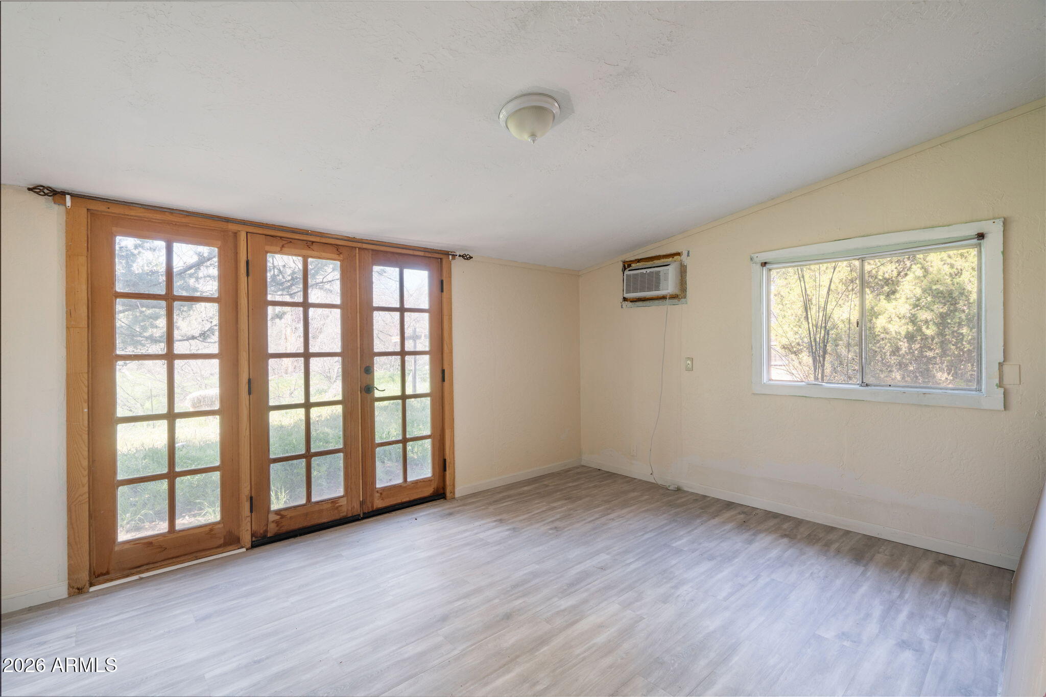 3775 East Sycamore Lane Rimrock, AZ 86335 - Photo 24 of 40 a view of an empty room with a window and wooden floor