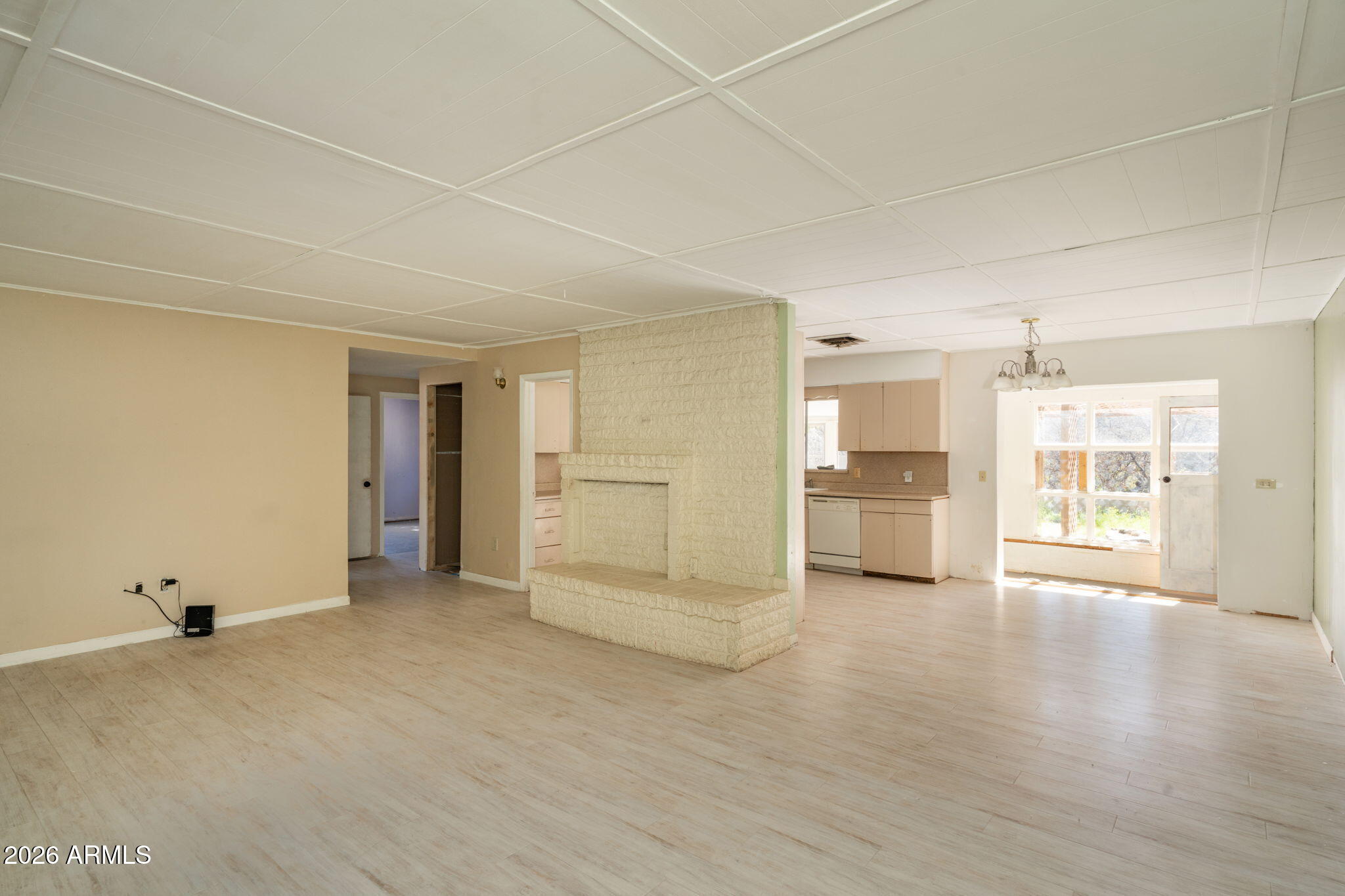 3775 East Sycamore Lane Rimrock, AZ 86335 - Photo 7 of 40 a view of empty room with wooden floor and kitchen view