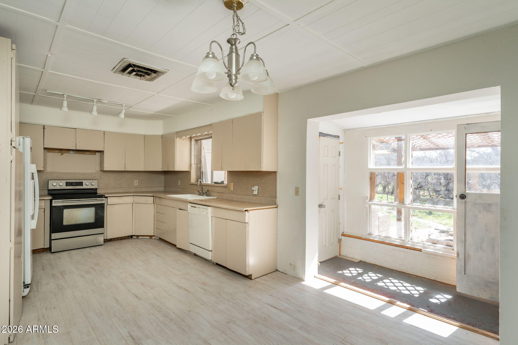 3775 East Sycamore Lane Rimrock, AZ 86335 - Photo 9 of 40 a large kitchen with a large window a sink and stainless steel appliances