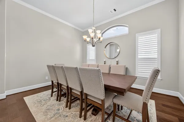 a view of a dining room with furniture wooden floor and chandelier