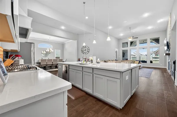 a large kitchen with stainless steel appliances lots of counter space and a sink
