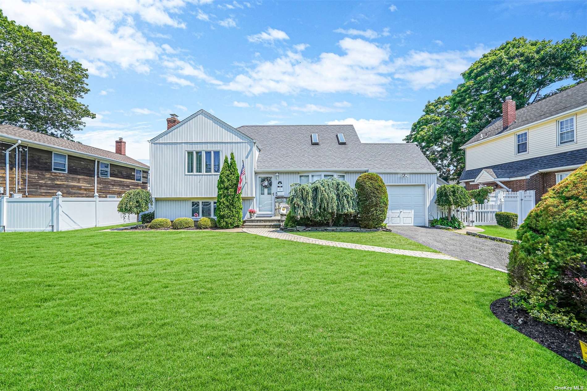 a front view of a house with a garden and plants