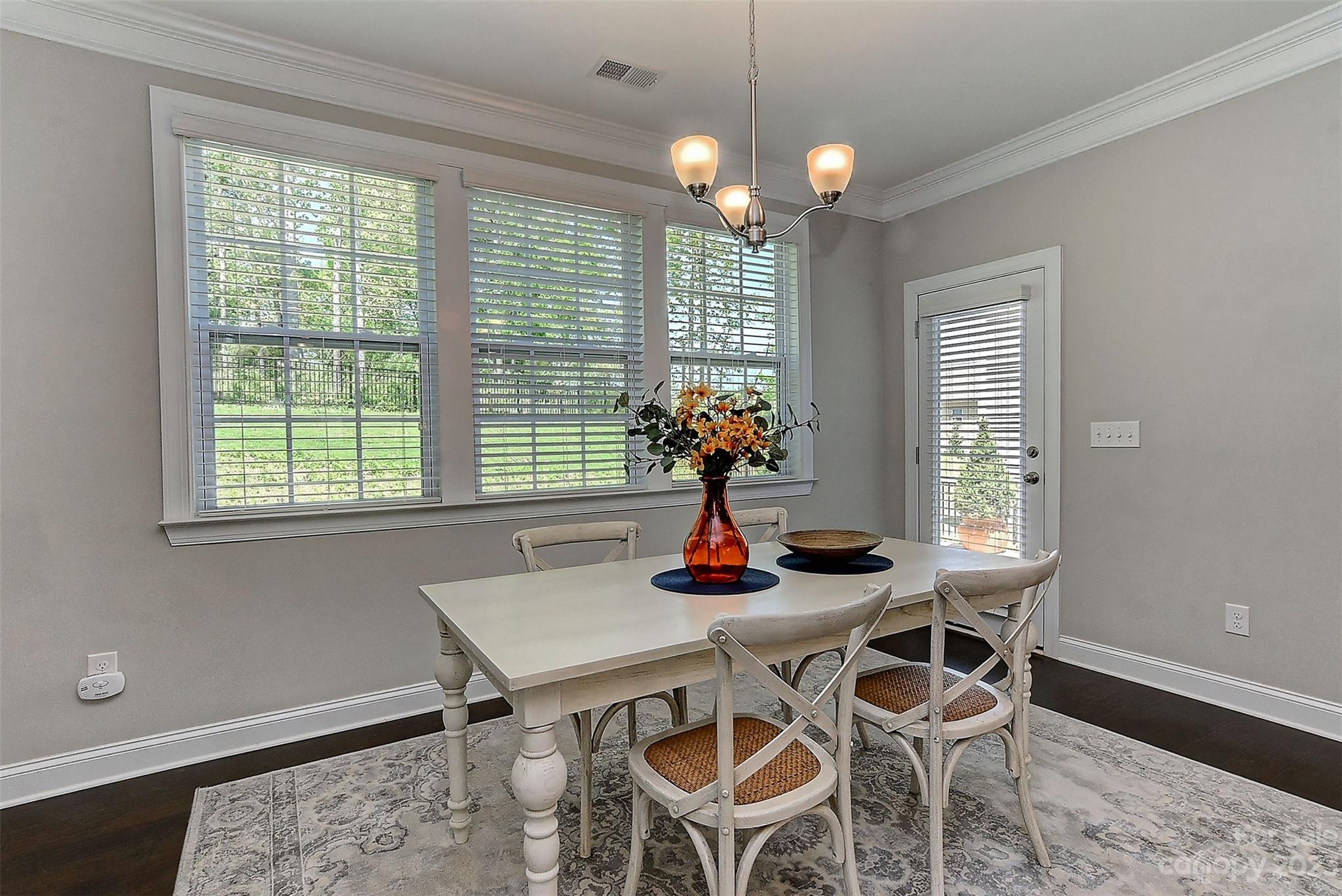 11266 Trailside Road Concord, NC 28027 - Photo 11 of 45 a view of a dining room with furniture wooden floor and chandelier