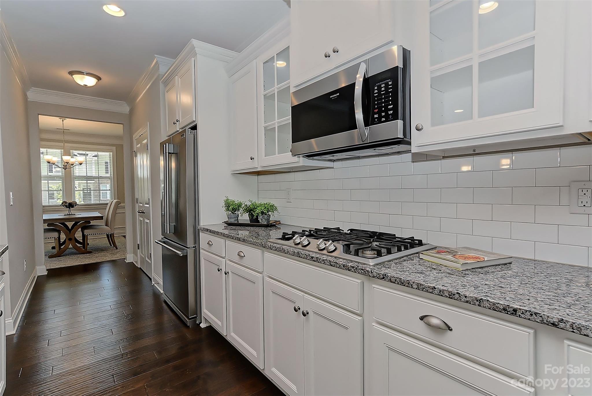 11266 Trailside Road Concord, NC 28027 - Photo 19 of 45 a kitchen with stainless steel appliances granite countertop a stove a microwave and cabinets