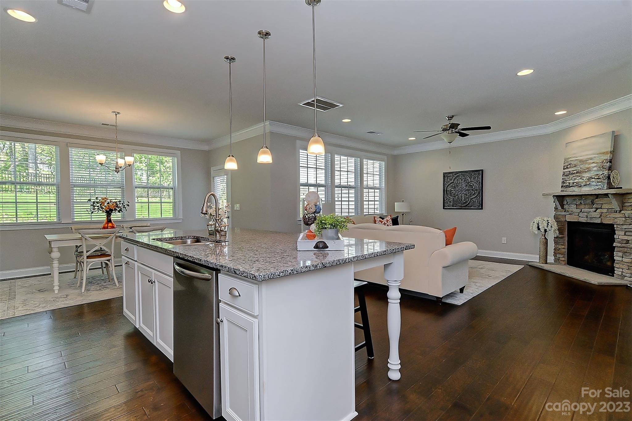 11266 Trailside Road Concord, NC 28027 - Photo 20 of 45 a open kitchen with stainless steel appliances granite countertop a stove and cabinets with wooden floor