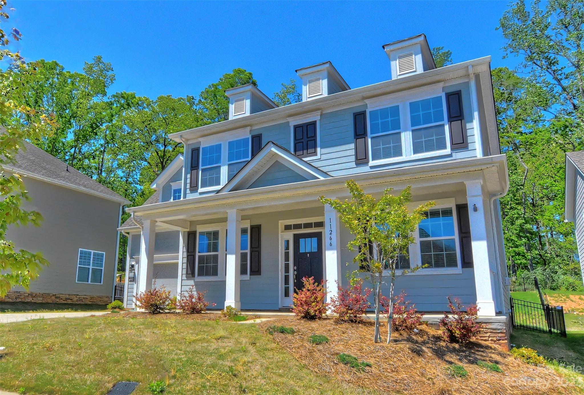11266 Trailside Road Concord, NC 28027 - Photo 2 of 45 front view of a brick house with a yard