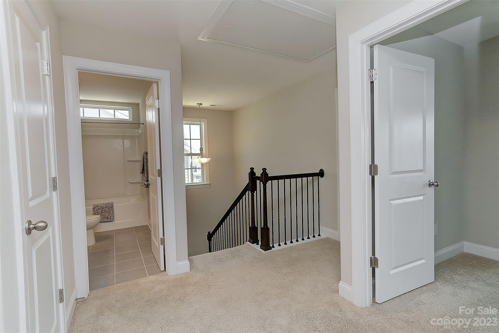 11266 Trailside Road Concord, NC 28027 - Photo 28 of 45 a view of a hallway with a livingroom and a hall with wooden floor